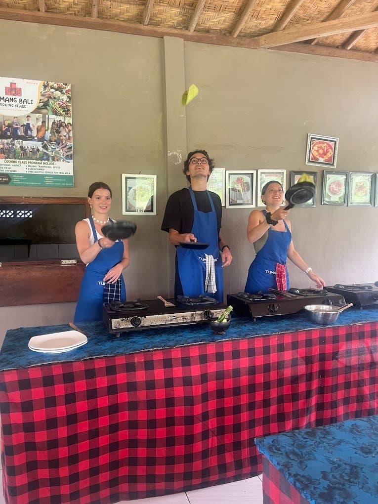 Guests flipping Dadar Gulung pandan crepes in the pan