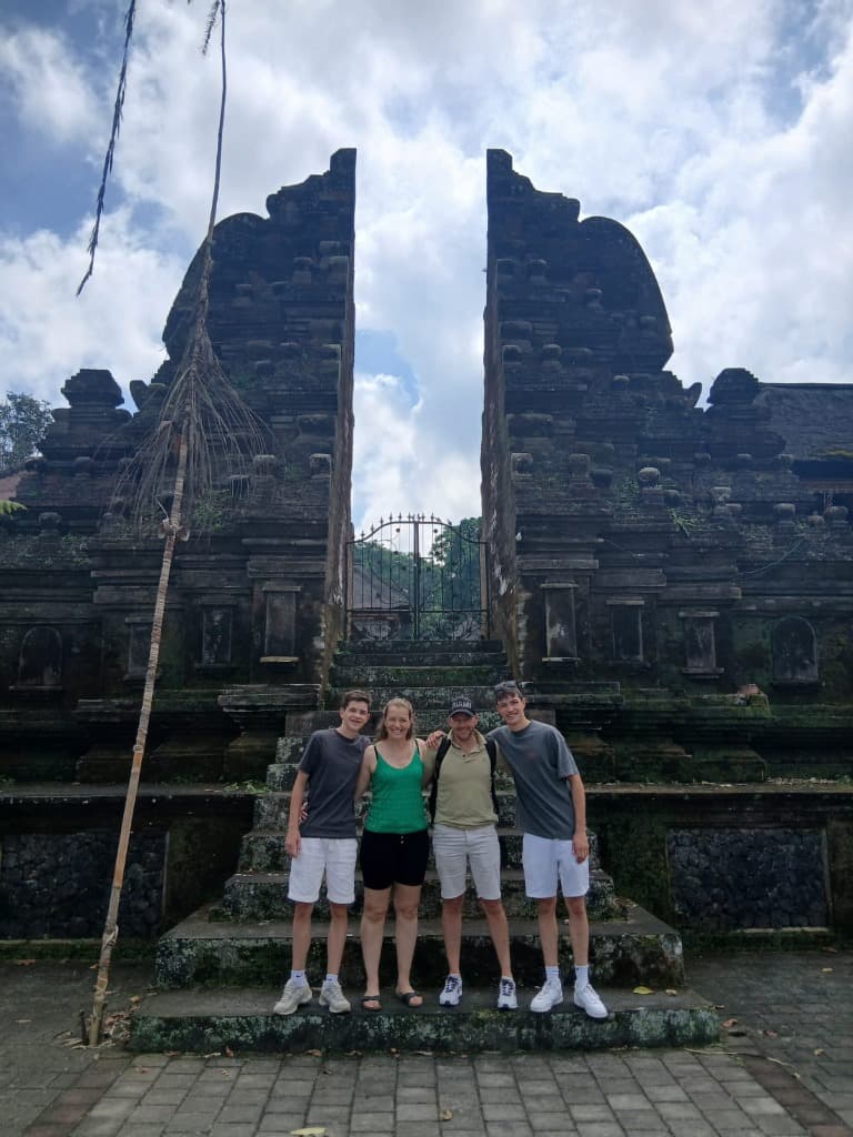 Group standing before ancient temple gates