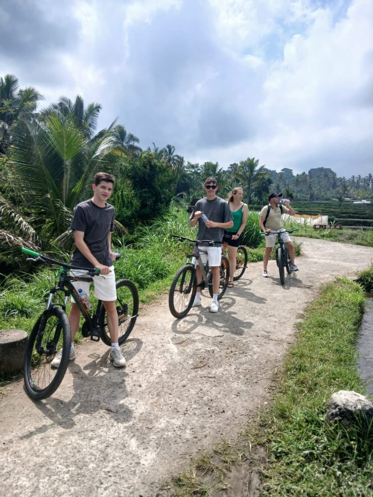 Group cycling along village trail